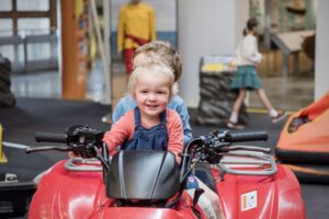 Young visitors climb aboard a rescue quad bike in the RNLI Rescue Zone Young visitors climb aboard a rescue quad bike in the RNLI Rescue Zone