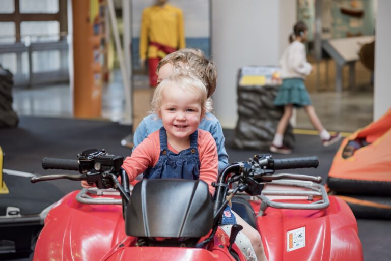 Young visitors climb aboard a rescue quad bike in the RNLI Rescue Zone Young visitors climb aboard a rescue quad bike in the RNLI Rescue Zone