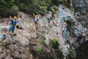Climbing family leaning back pose nature landscape 300x200